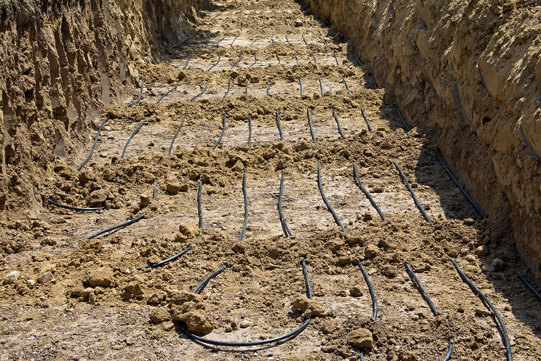 Geothermal loops in residential dirt trench for geothermal installation